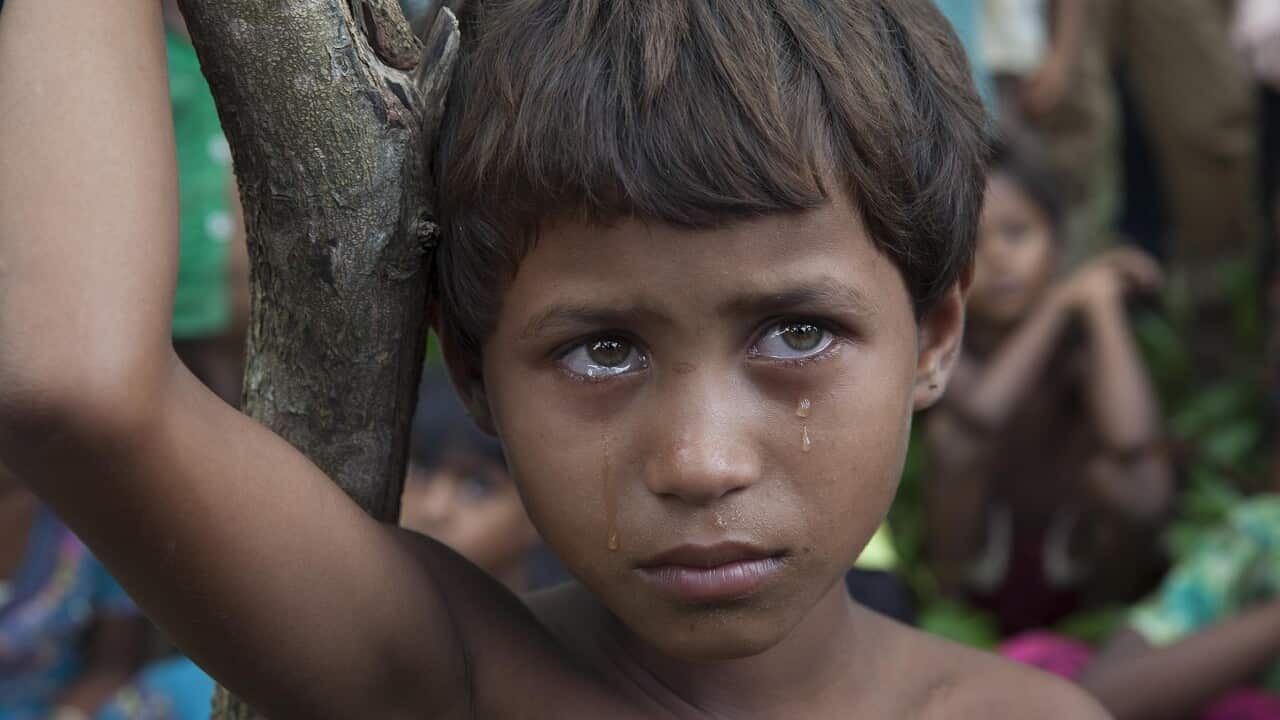 A Rohingya Muslim child sheds tears as it along with other refugees had crossed over to Bangladesh at the Kutubalam area.