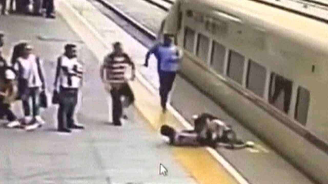 Dramatic rescue as girl jumps in front of moving train in China | SBS News