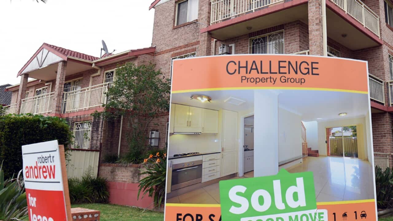 A "for sale" sign is seen outside an apartment