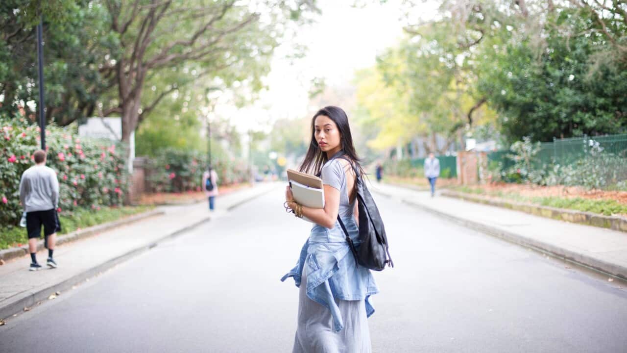 University college student on walking with books