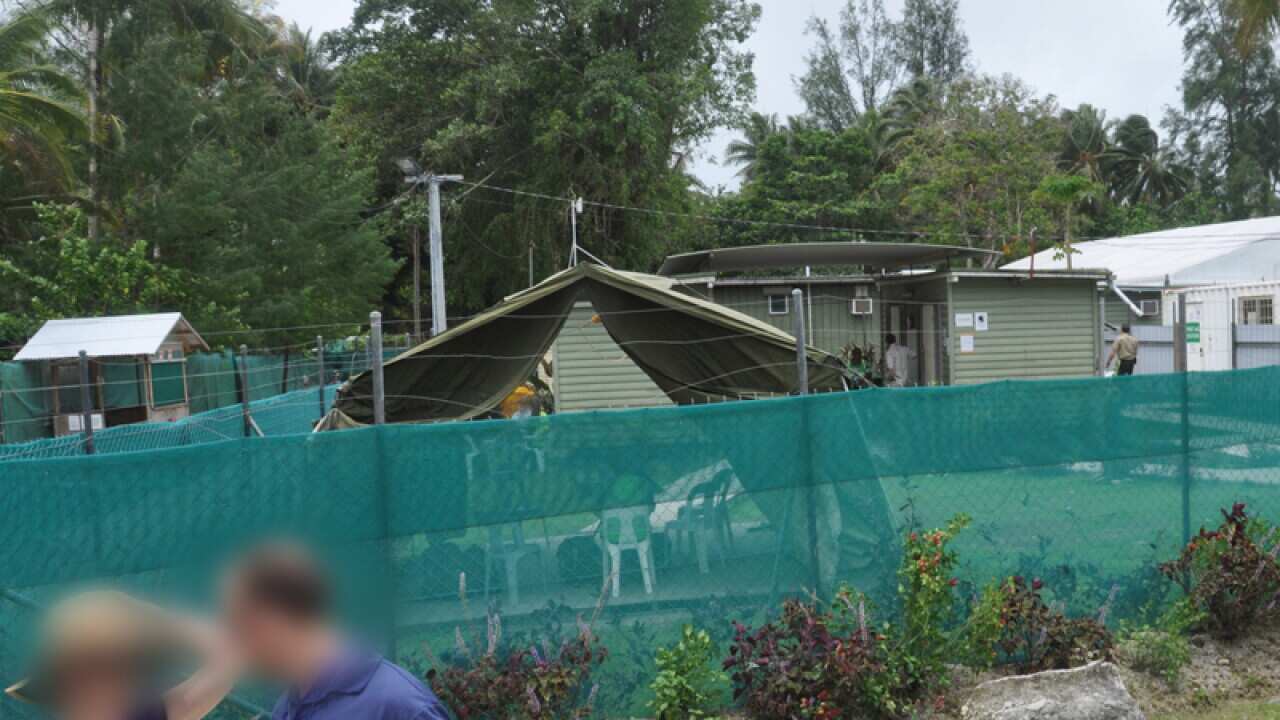 A green mesh fence surrounds Oscar compound at Manus Island