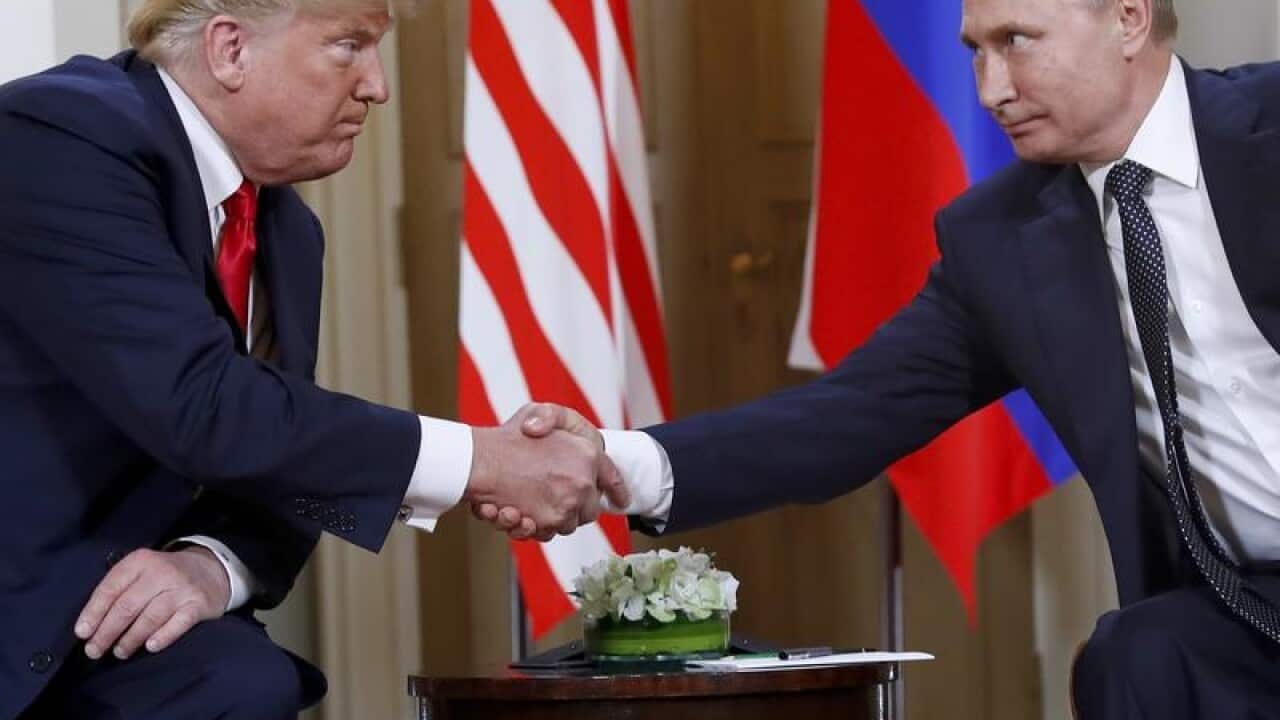 A file image of President Trump and President Putin shaking hands