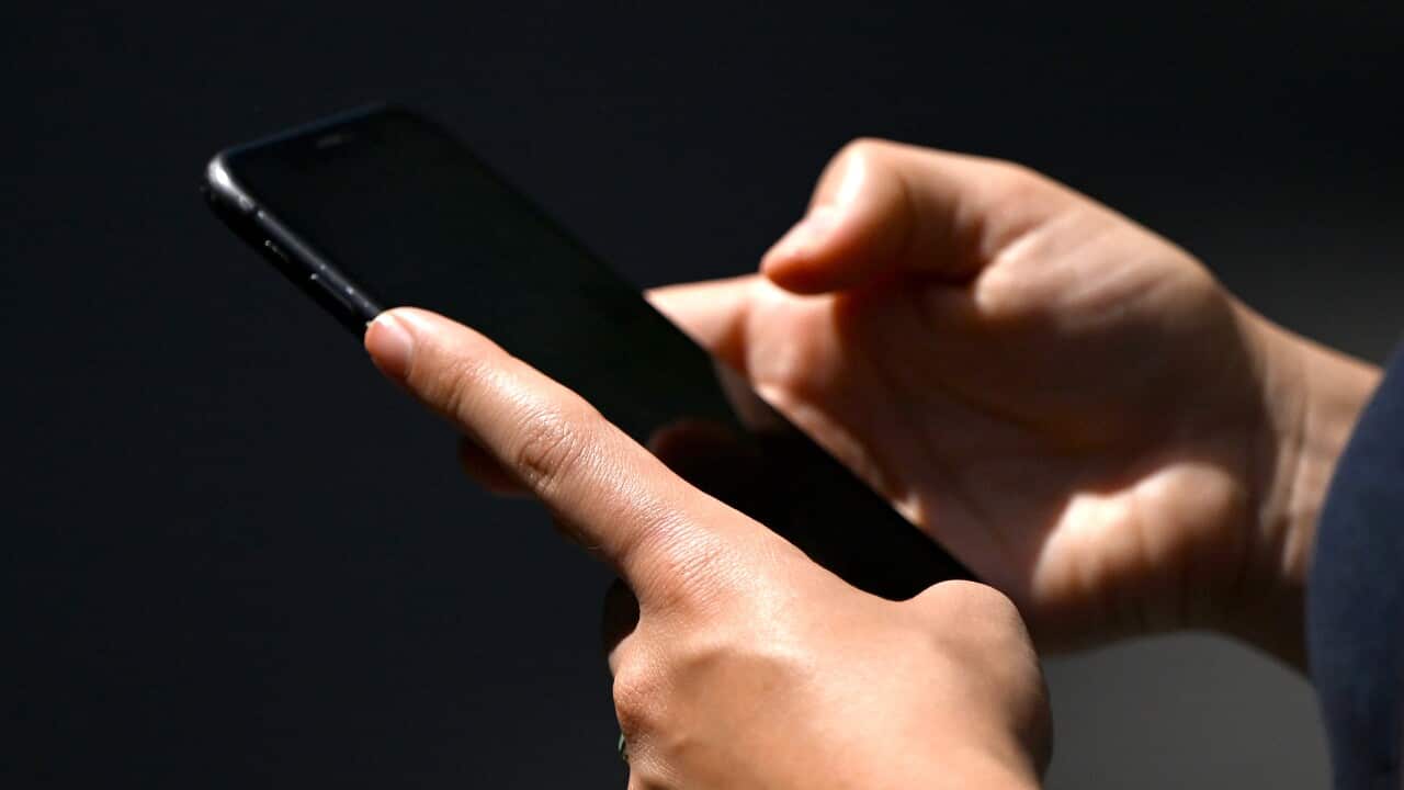 A woman seen using a smartphone device