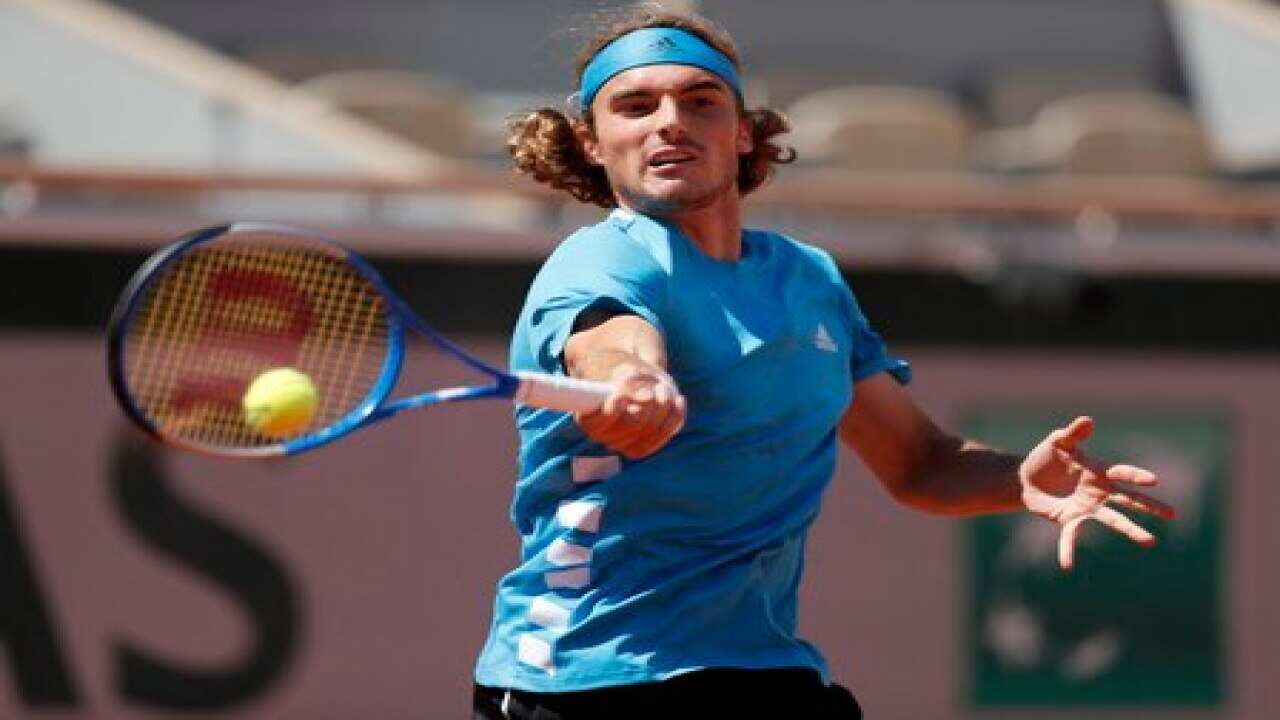Tsitsipas sweats into French Open fourth round