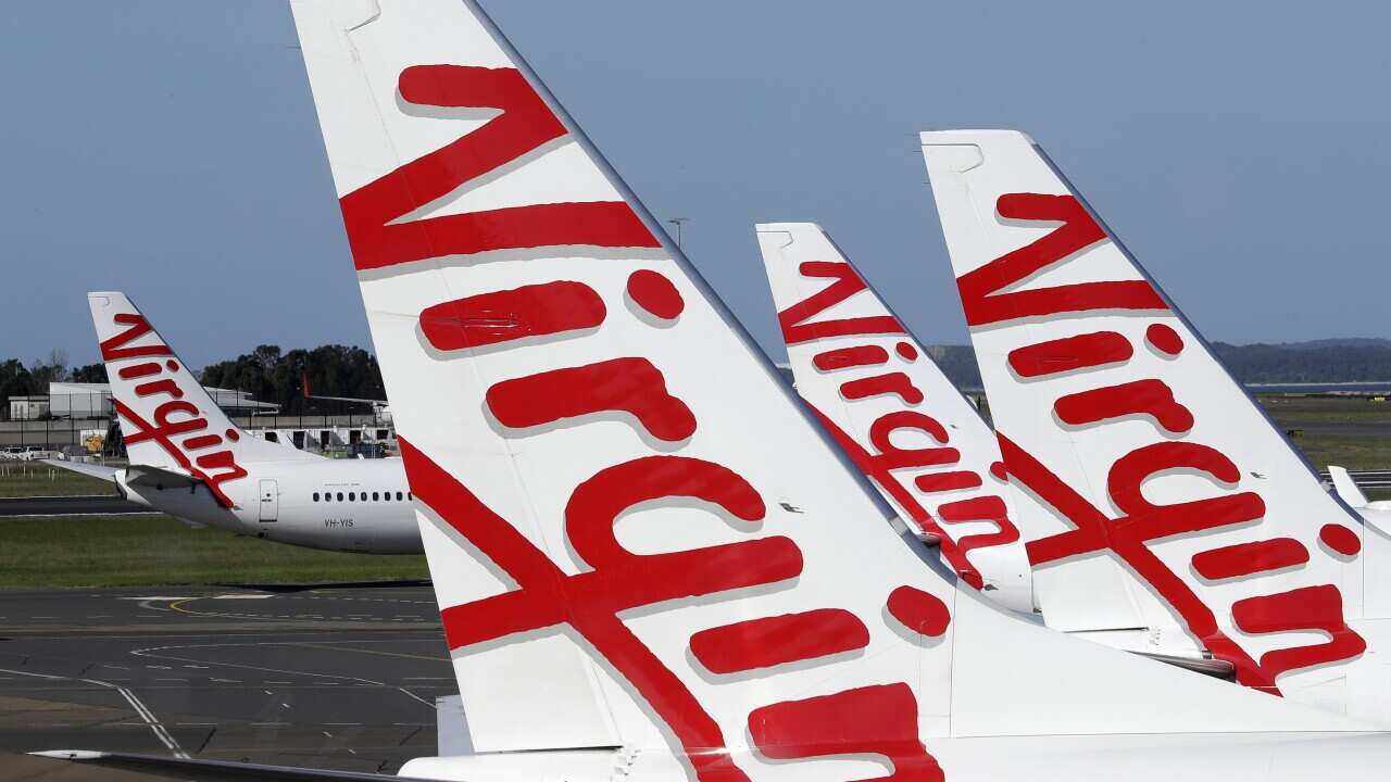 Virgin Australia planes at departure gates at Sydney Airport, Wednesday, 22 April, 2020.