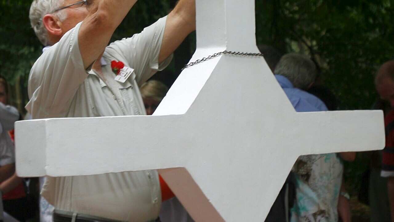 An Australian Veteranput his hat on the cross of the Long Tan Battle at Vung Tau province, Vietnam, Friday 18 August 2006.