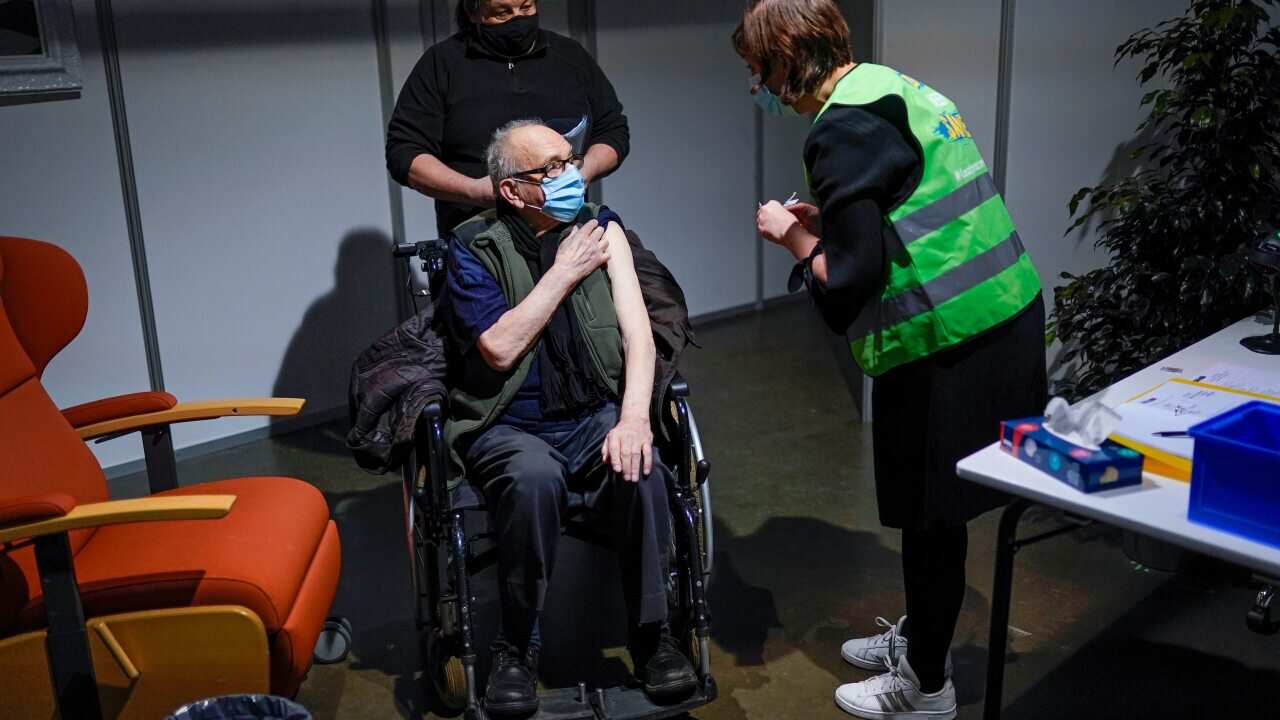 A man receives his first dose of the AstraZeneca's Covid-19 jab, in a mass vaccination site at the Brabanthal event center in Heverlee, Belgium o17 March 2021.