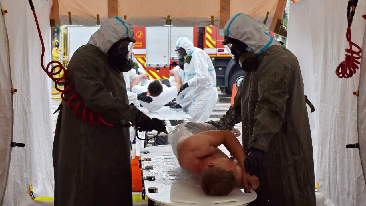 Ukrainian emergency workers practice decontaminating a man from radiation during training on radiation exposure in Zaporizhzhia (AAP).