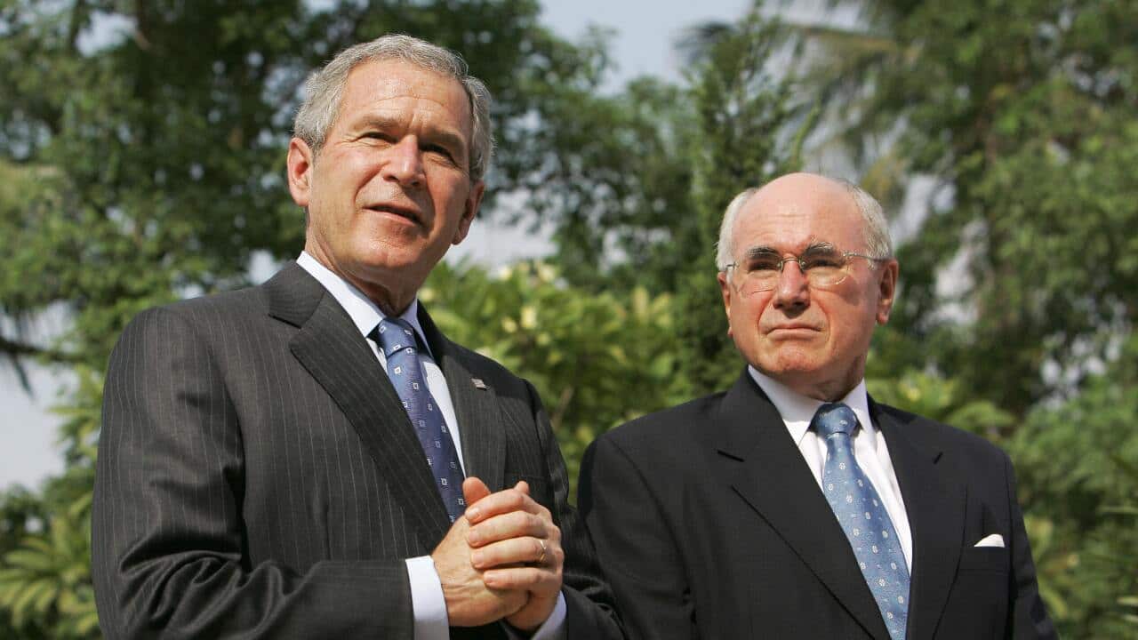 Two men in suits standing outside