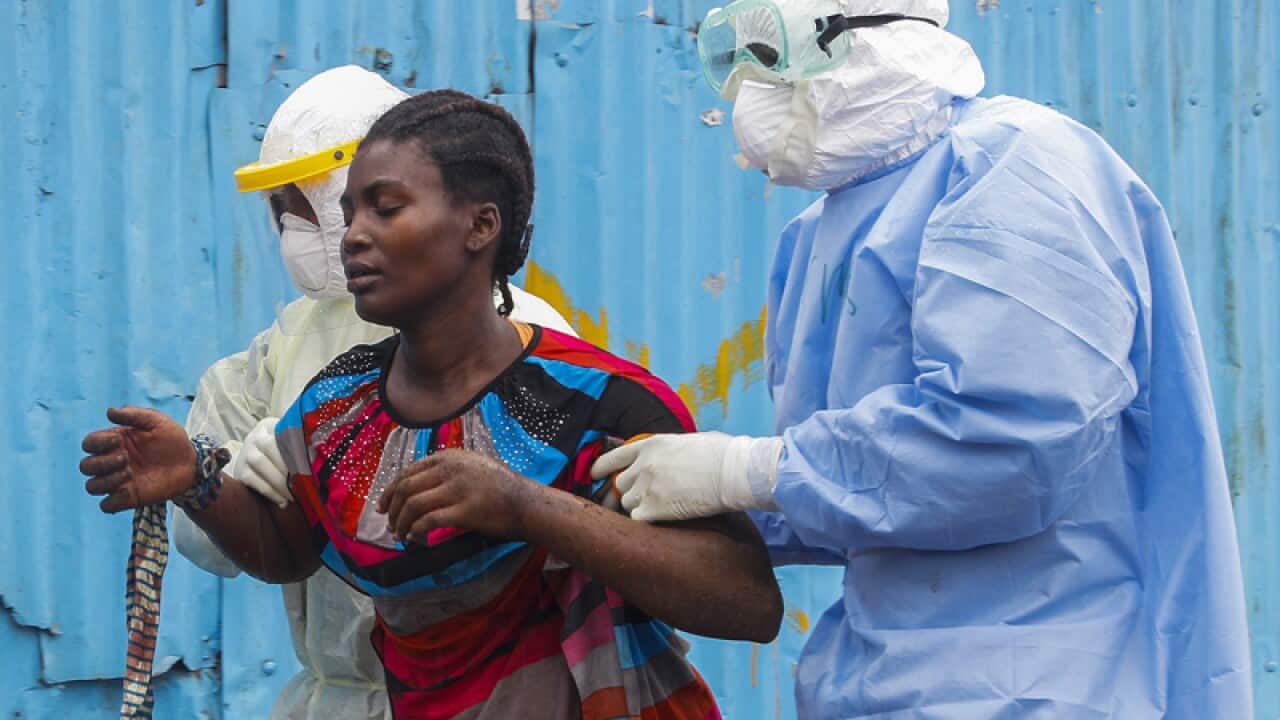 Liberian nurses escort a suspected Ebola patient