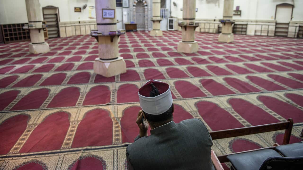 epa08326292 A Muslim cleric of Abou Al Hana mosque waits ahead of Friday congregational prayer that was held without faithful, in Cairo, Egypt, 27 March 2020. Egyptian religious institutions on 21 March ordered the suspension of group prayers and Friday p