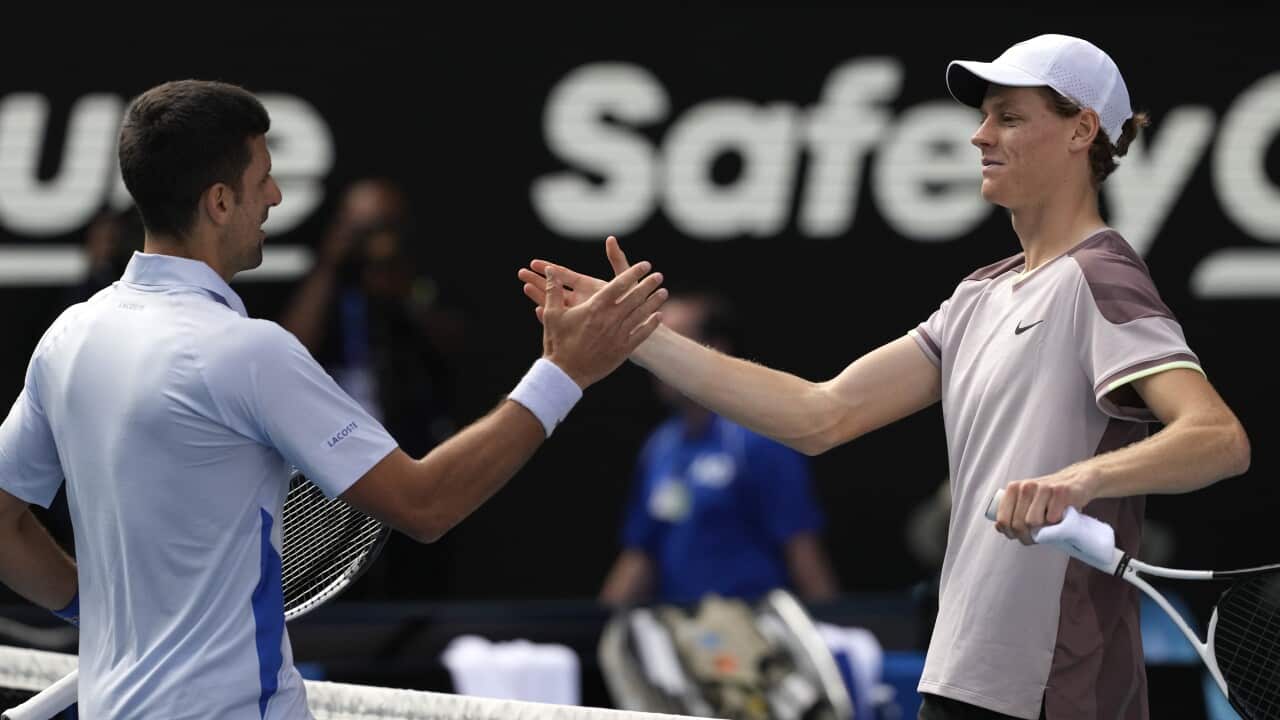 Jannik Sinner of Italy is congratulated by Novak Djokovic of Serbia following their semifinal at the Australian Open tennis championships at Melbourne Park