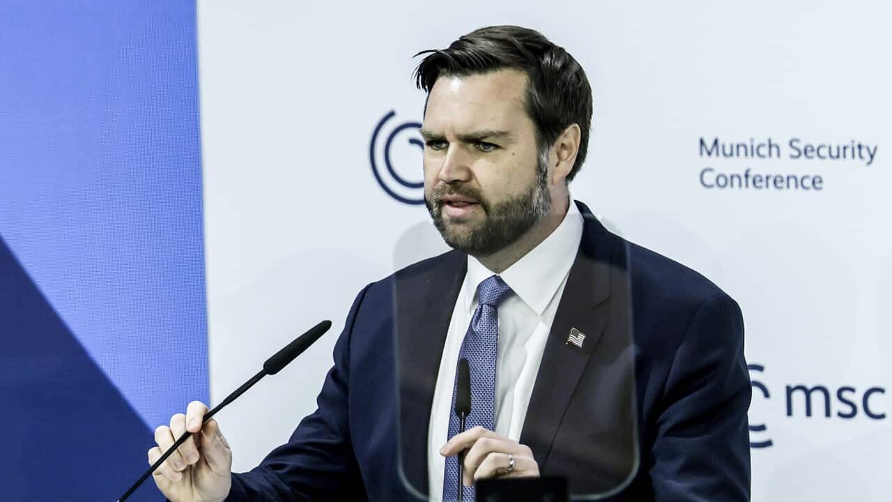 A man speakings at a podium.