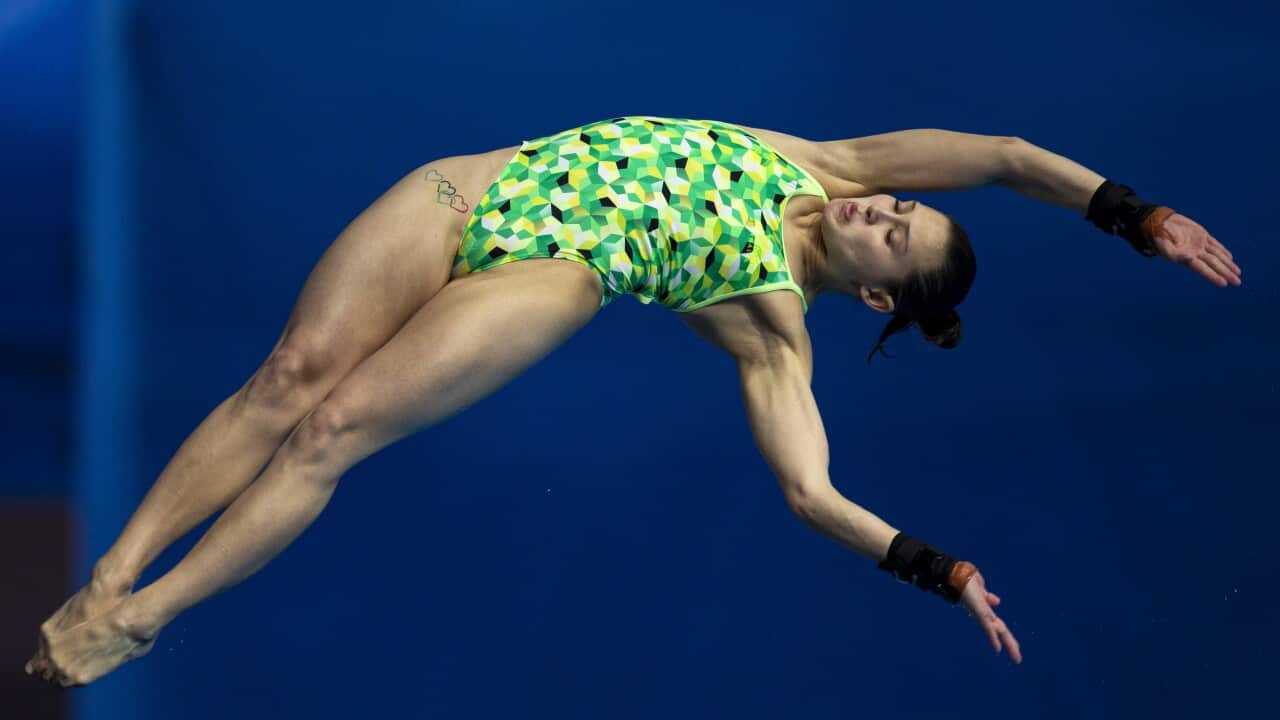 Melissa Wu mid air, competing in platform diving.