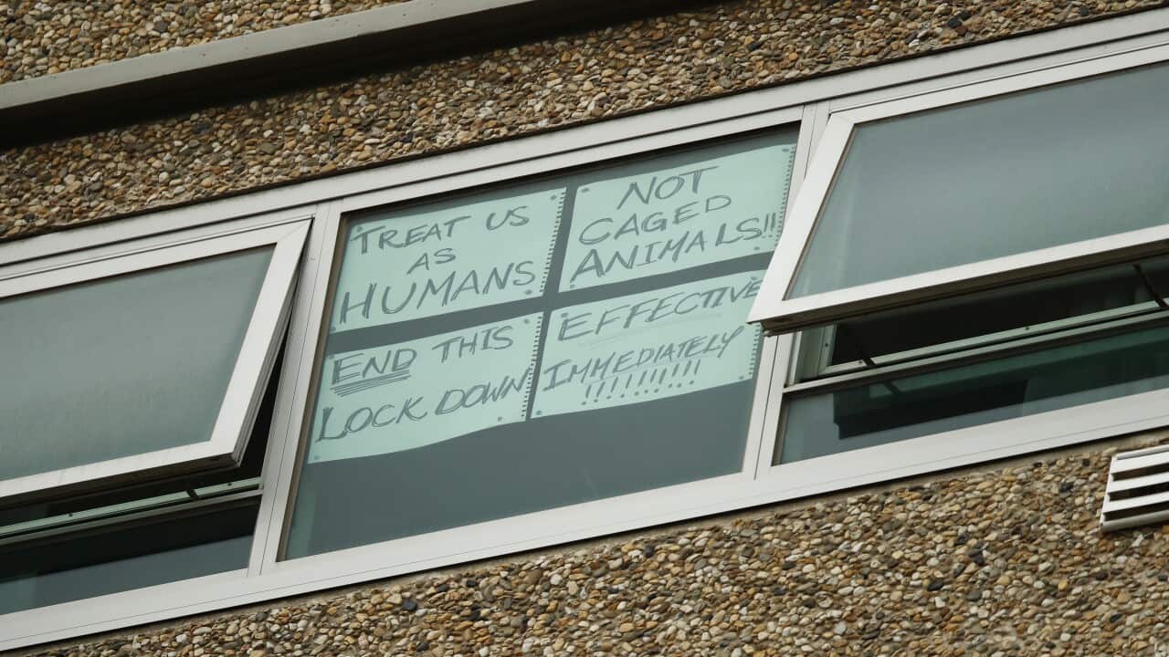 A sign is seen on a window at one of the public housing towers on Racecourse Road in Flemington, Melbourne.