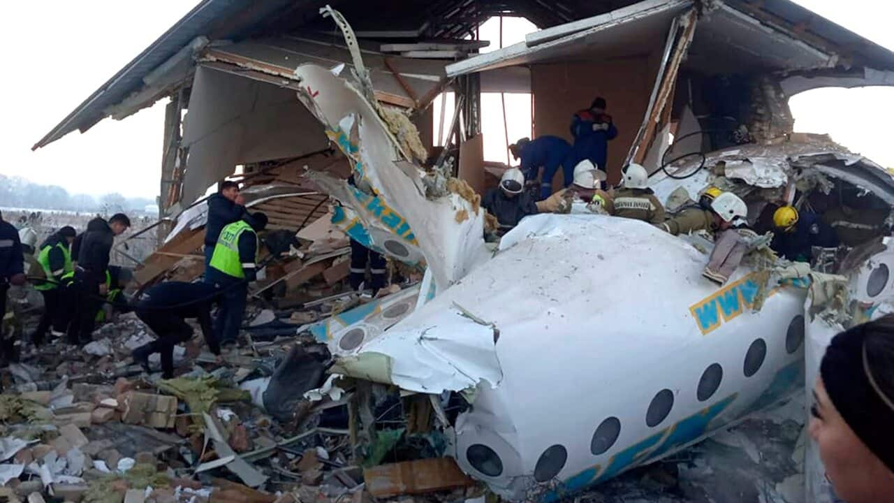 Rescuers get to work at a plane crash near Almaty International Airport, outside Almaty, Kazakhstan.