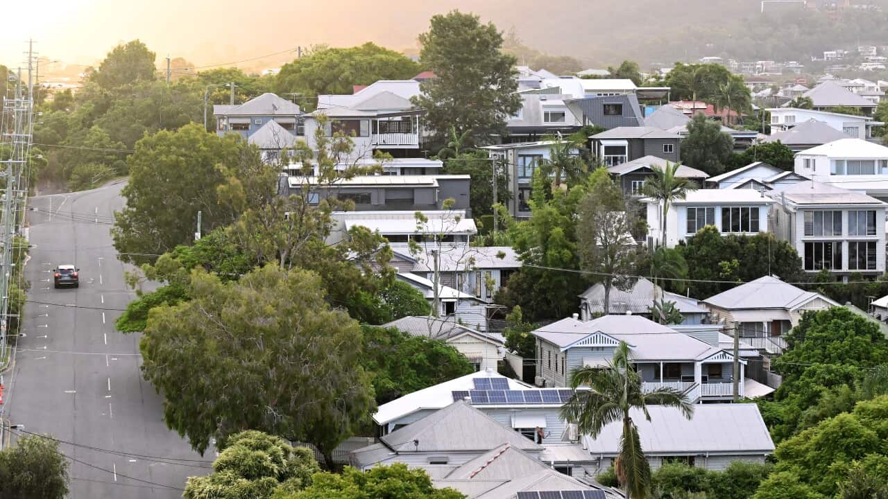 An aerial view of houses on a suburban street.