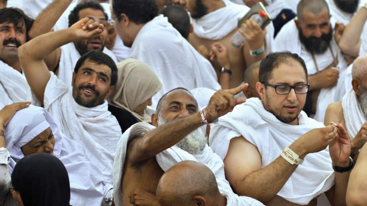 Muslim pilgrims cast stones at a pillar, symbolising the devil