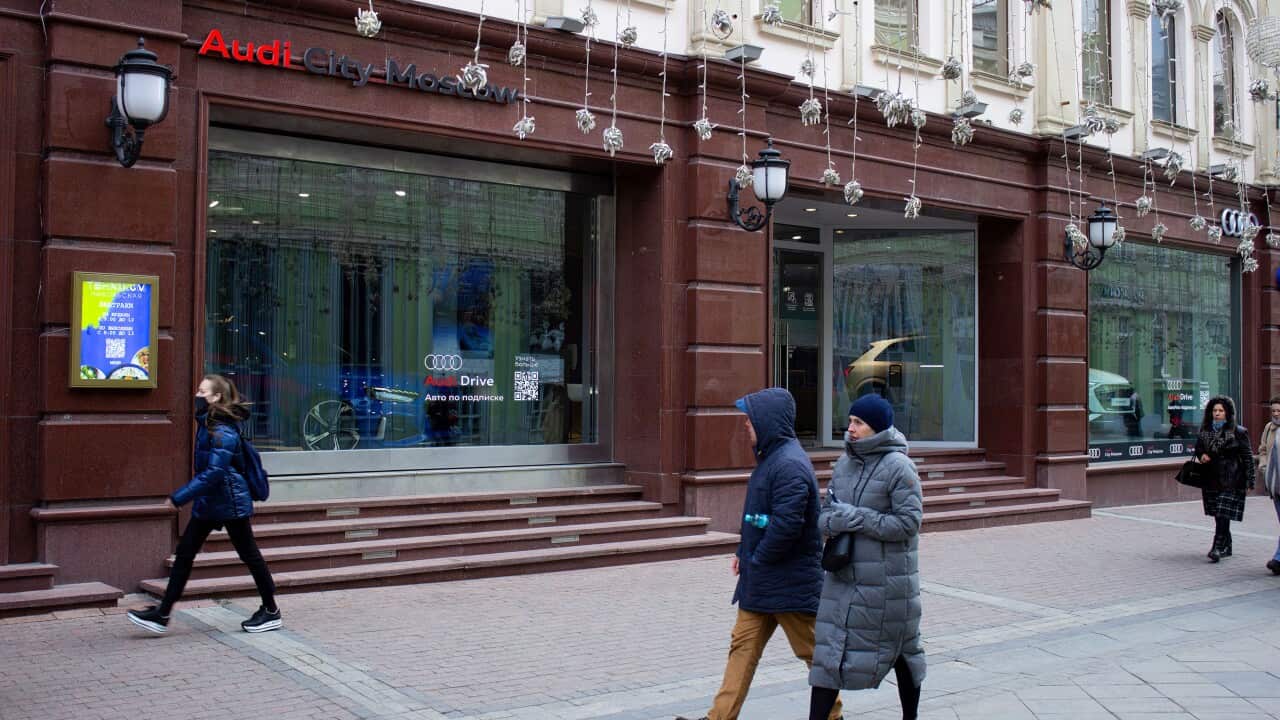 People walk by an Audi boutique on Nikolskaya street in Moscow.