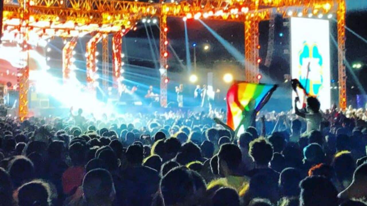 Ahmed Alaa raises the rainbow flag at a concert in Cairo in 2017.