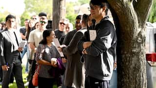A group of people at a house auction.