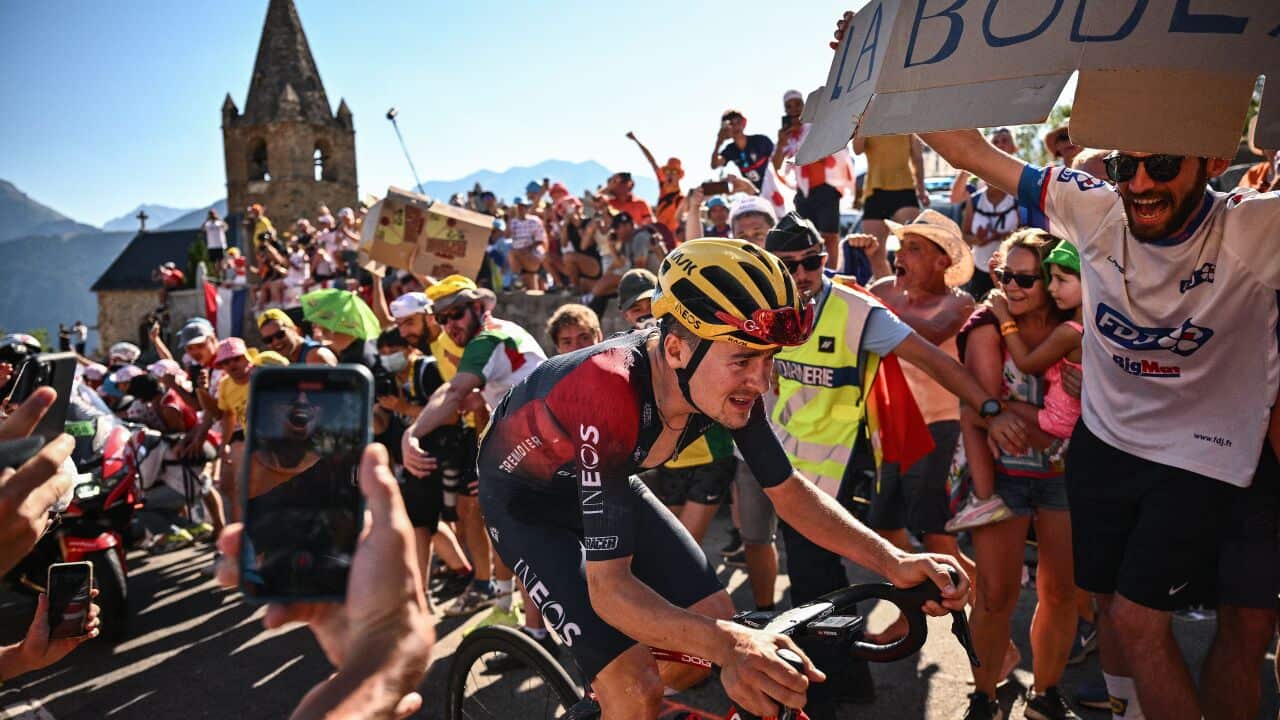 Tom Pidcock battles through the fans and up the climb of the Alp D'Huez on Stage 12 of the Tour de France.
