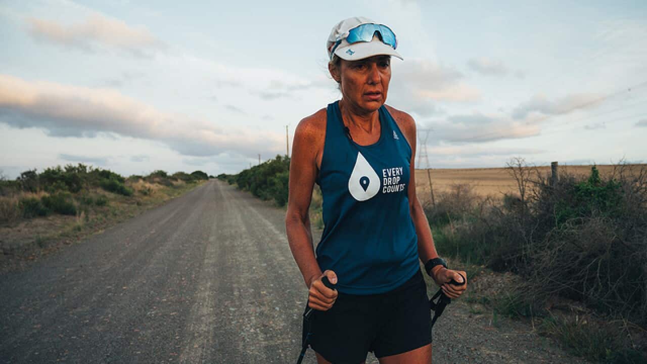 Mina Guli using walking sticks to complete a marathon due to injury between Mossel Bay and Riverdale in South Africa.