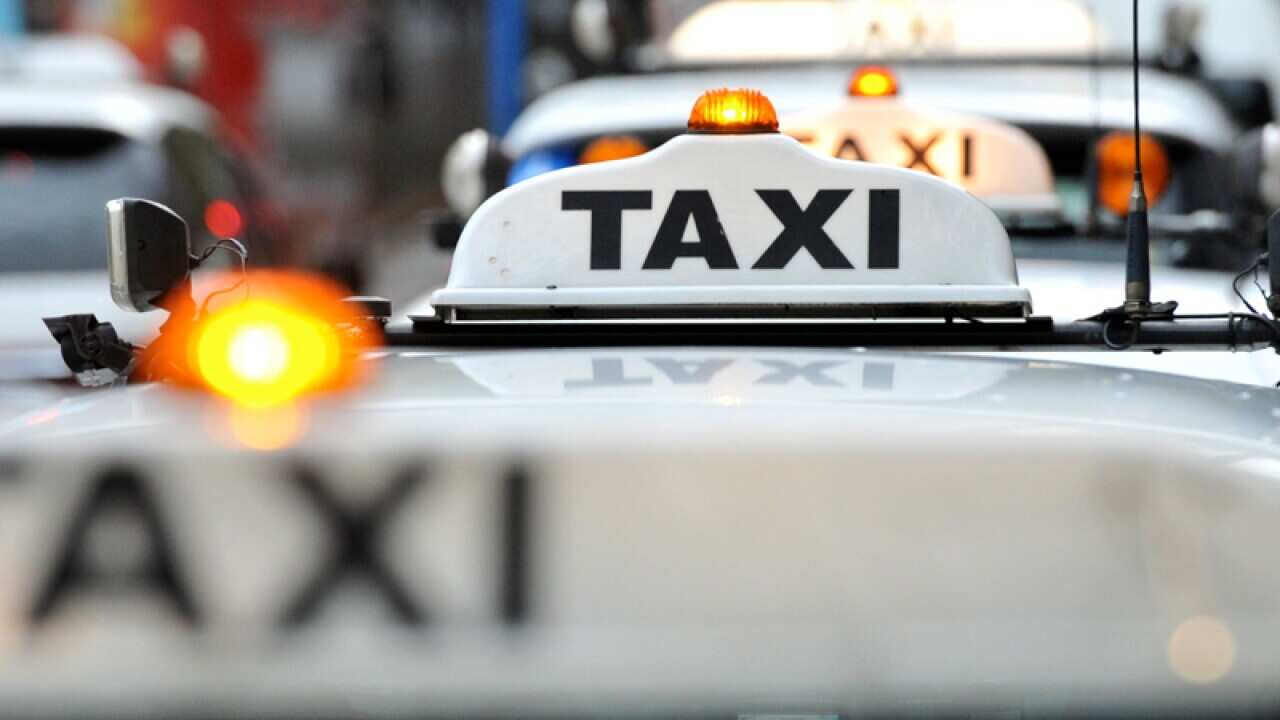 A taxi waits at a rank at Circular Quay