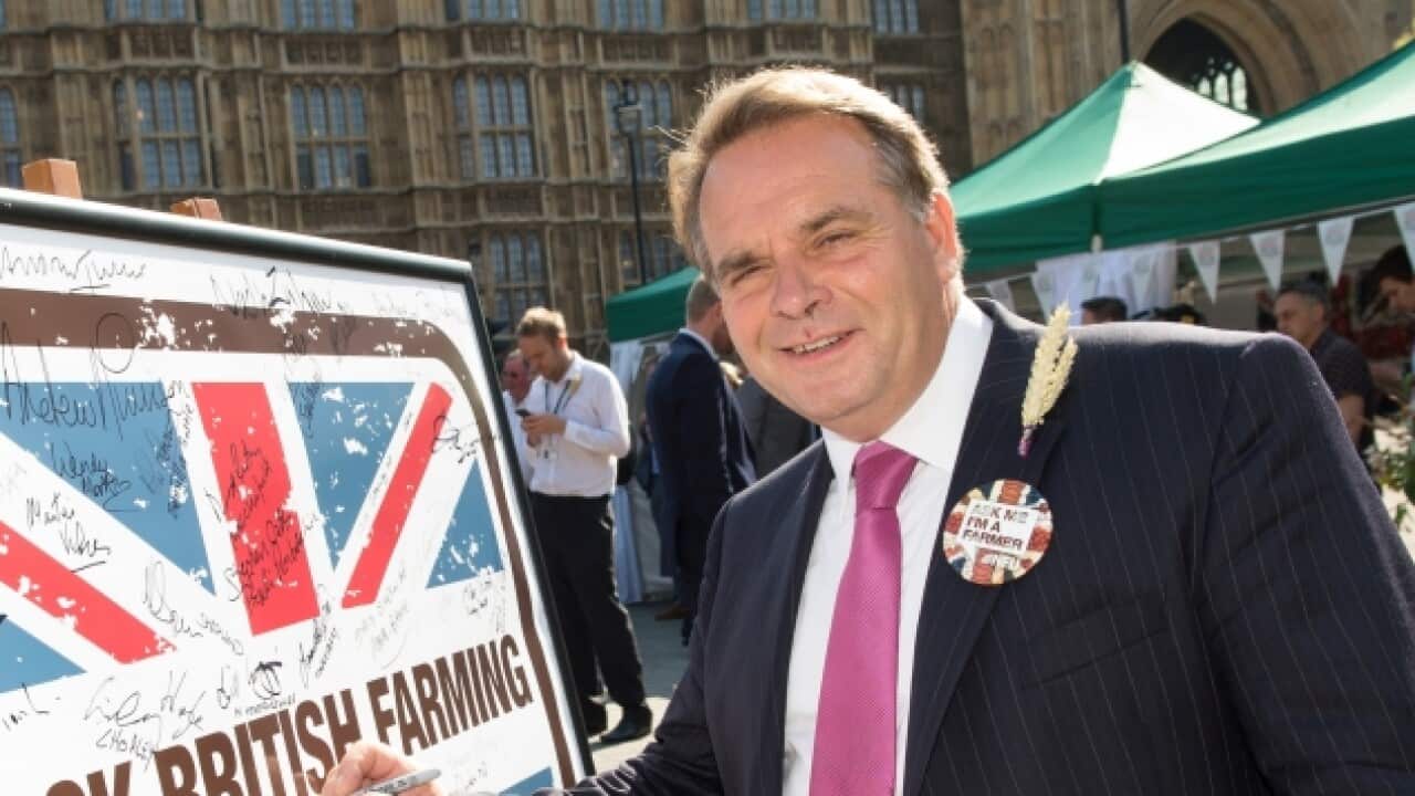 A man standing outside the United Kingdom's House of Commons.