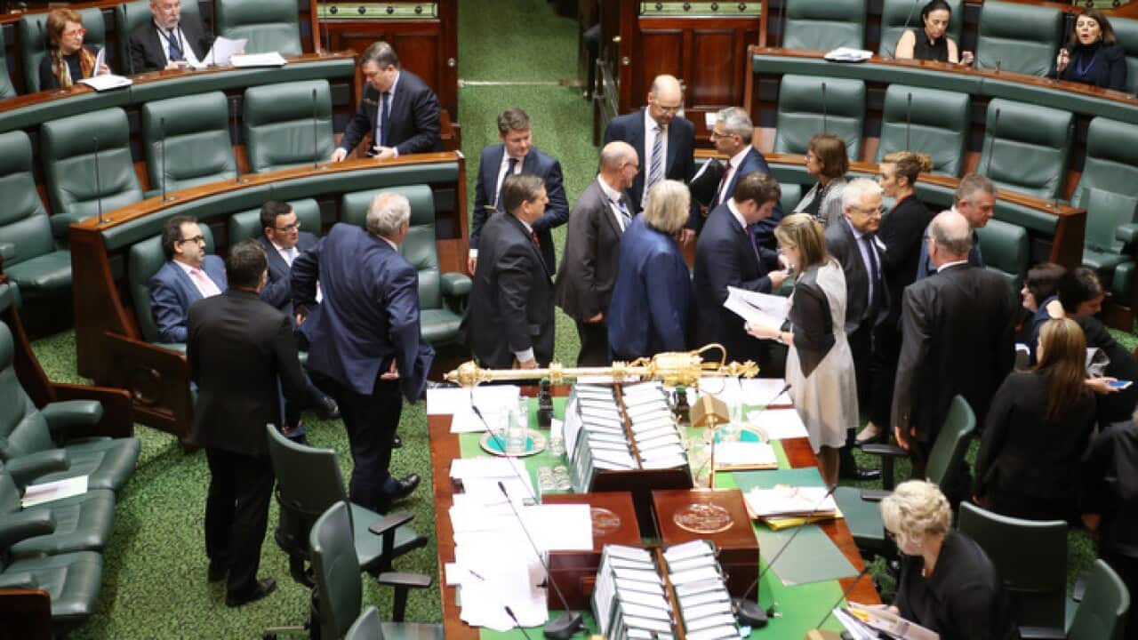 Members move around the chamber as they vote on an amendment to the Voluntary Assisted Dying Bill 2017 as it is debated in the lower house at the Victorian Parliament in Melbourne, Thursday, October 19, 2017. (AAP Image/David Crosling) NO ARCHIVING