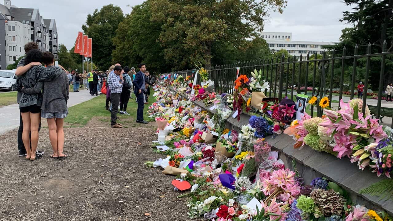 Mourners stop at the floral memorial near Christchurch's Botanical Gardens