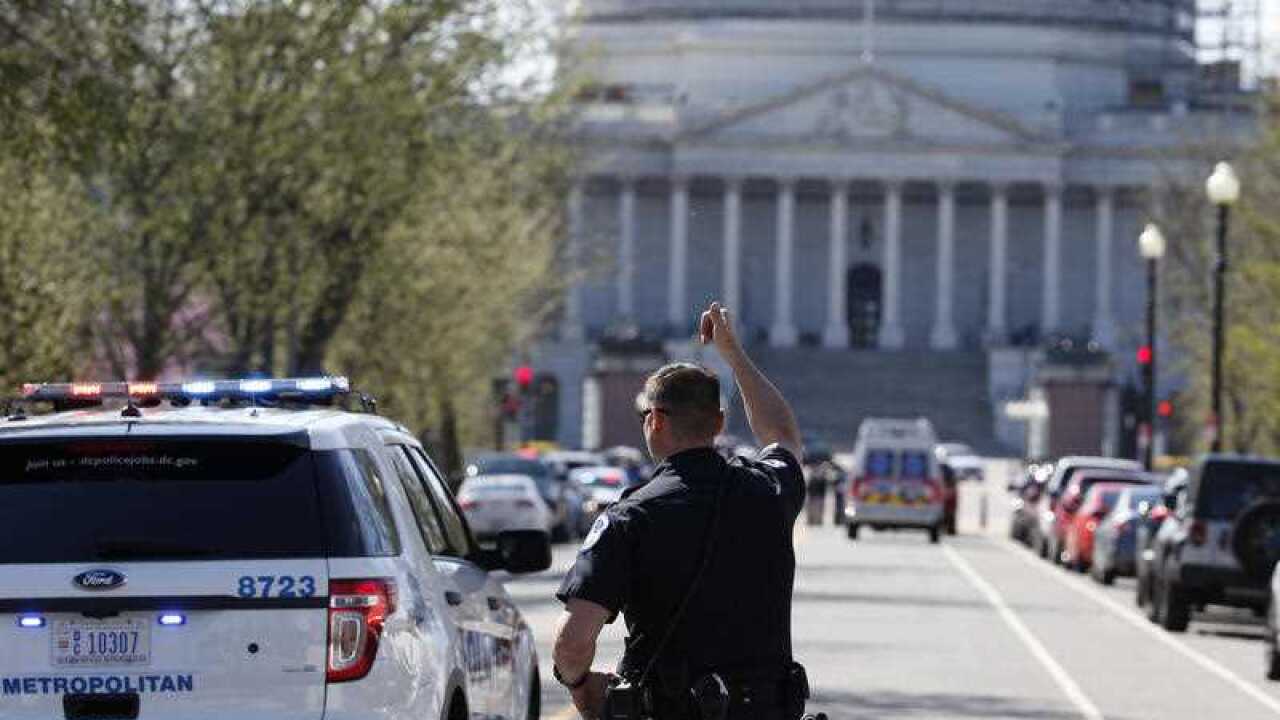 Law enforcement and rescue vehicle are seen on a street leading to Capitol Hill in Washington, Monday, March 28, 2016