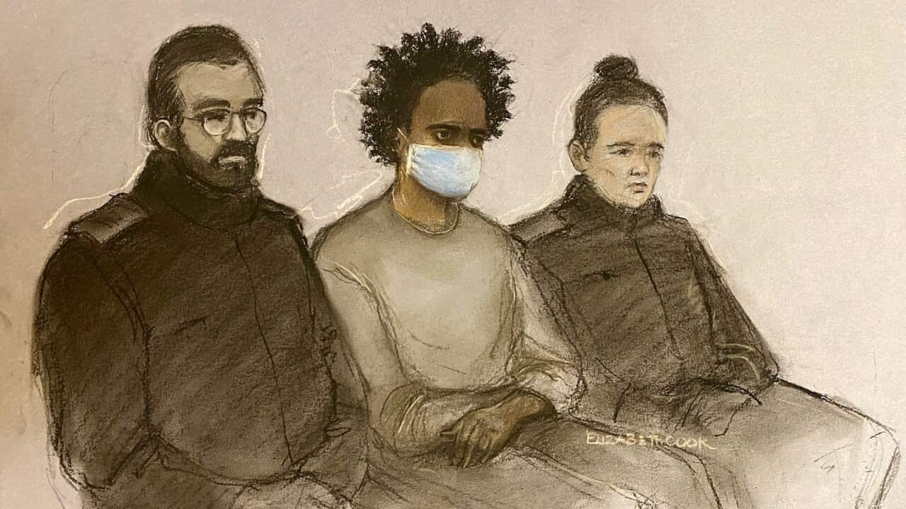 A court sketch shows three people seated, with one in the middle wearing a surgical mask.