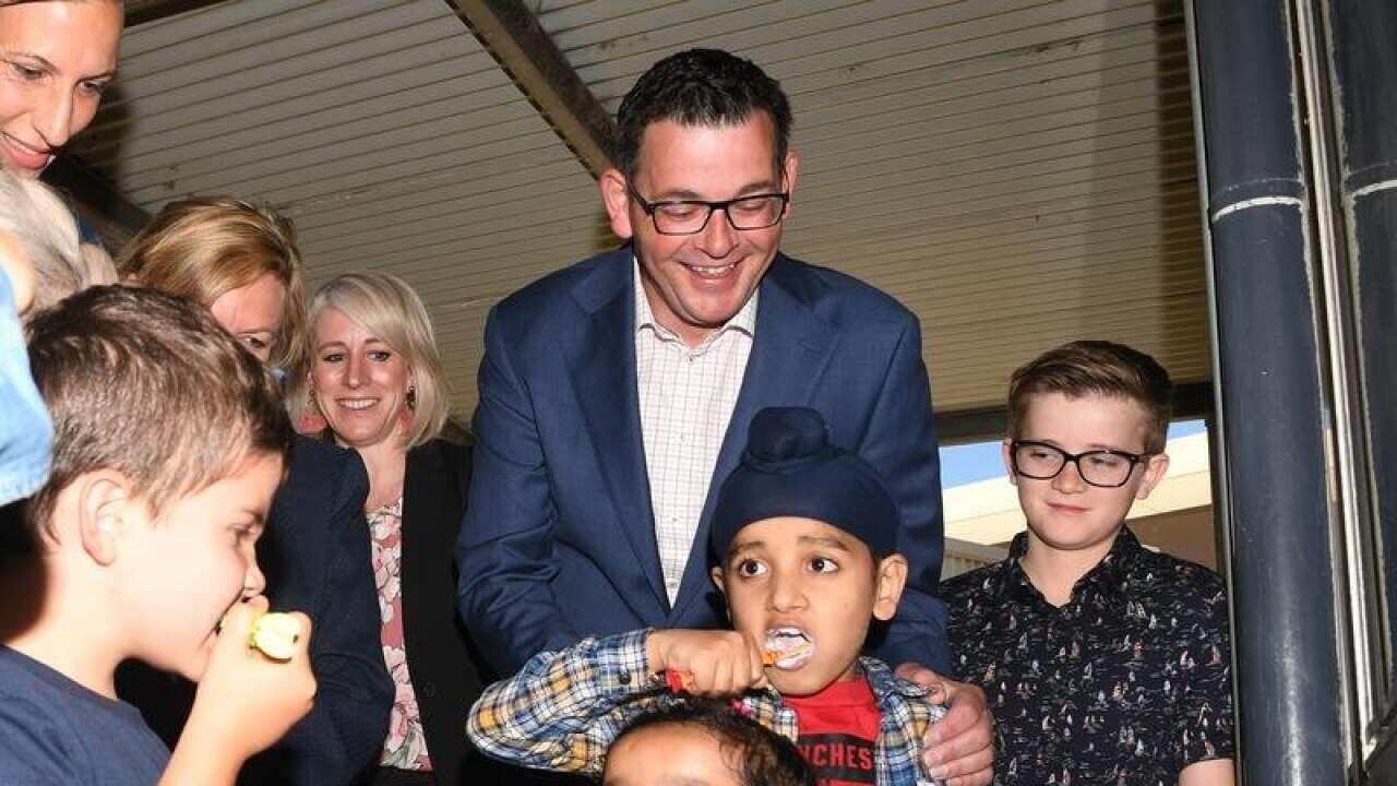 Victorian Premier Daniel Andrews with kids brushing their teeth