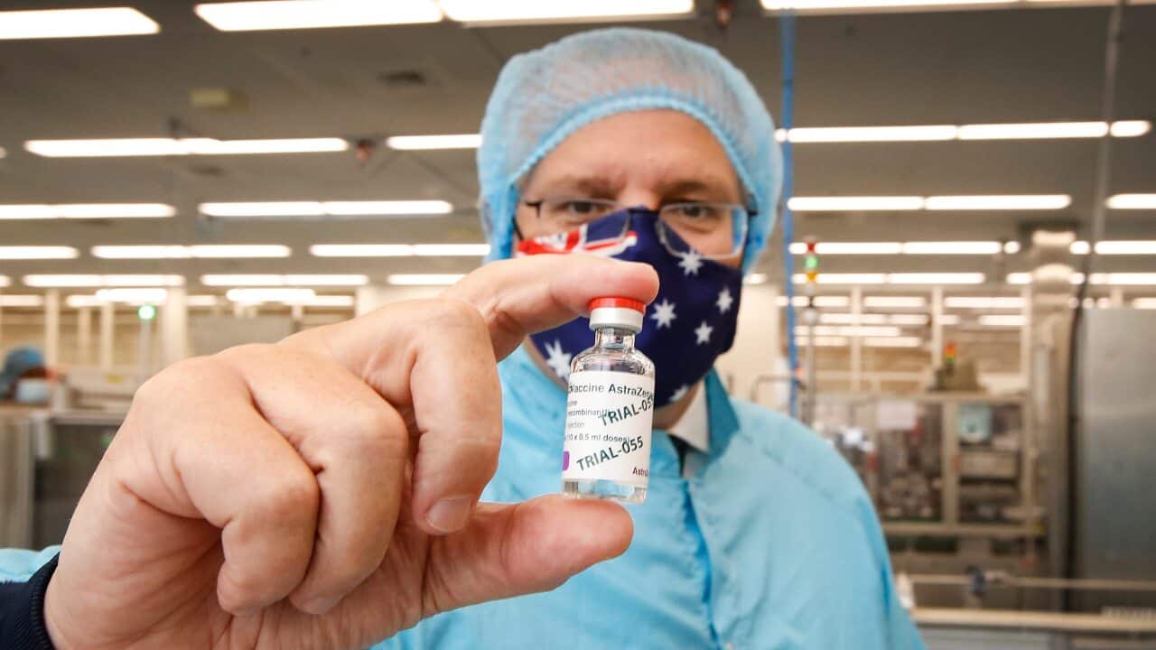 Prime Minister Scott Morrison holds a vial of AstraZeneca's coronavirus vaccine during a visit to the CSL lab in Parkville, Melbourne.