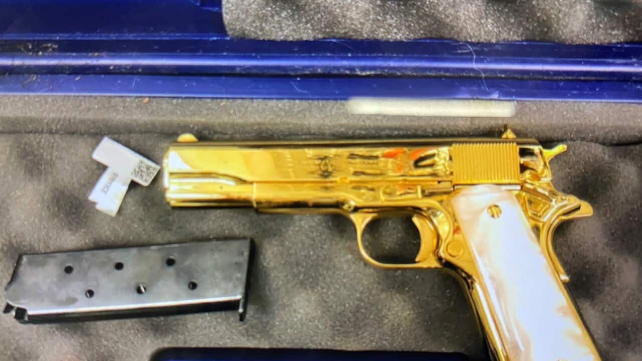 A gold plated gun in a padded case.