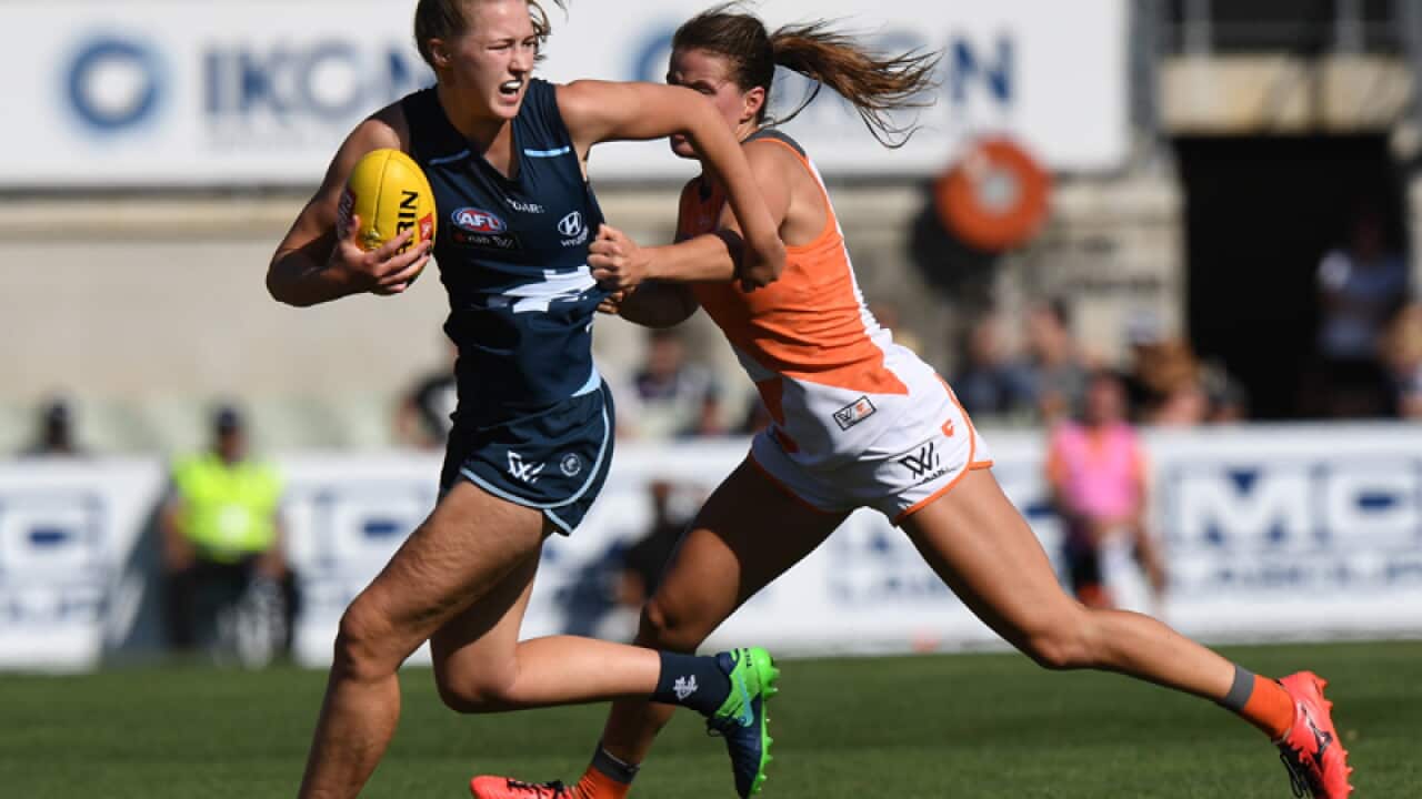 Alison Brown of Carlton fends off Nicola Barr of the GWS Giants