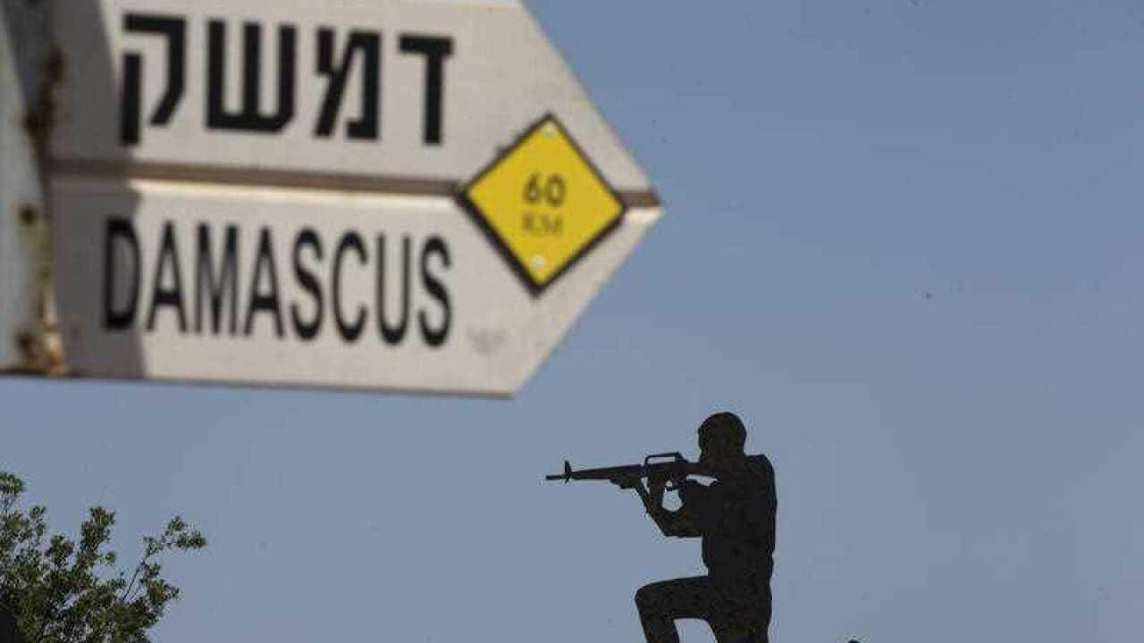 A mock road sign for Damascus, the capital of Syria, and a cutout of a soldier, are displayed in an old outpost in the Israeli controlled Golan Heights near the border with Syria, Thursday, May 10, 2018.