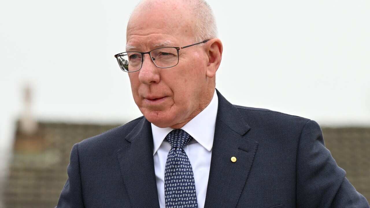 A man wearing a suit walking.