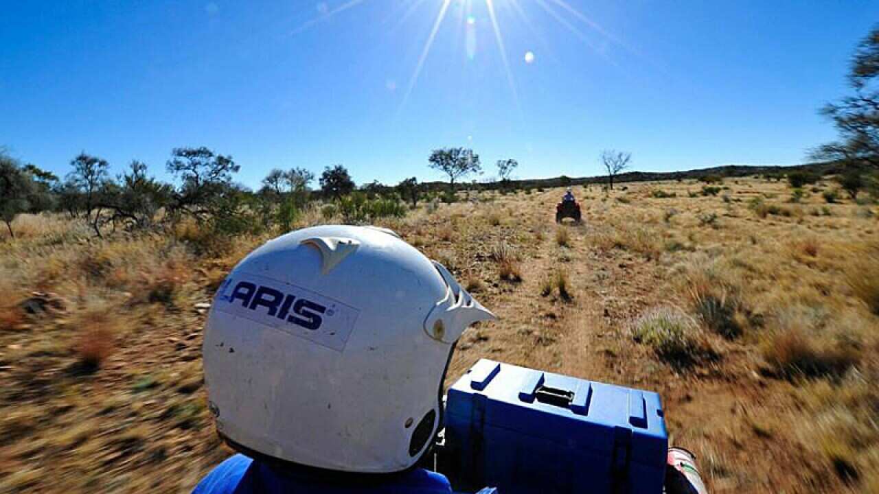 Tourists riding quad bikes on Undoolya Station, in Alice Springs