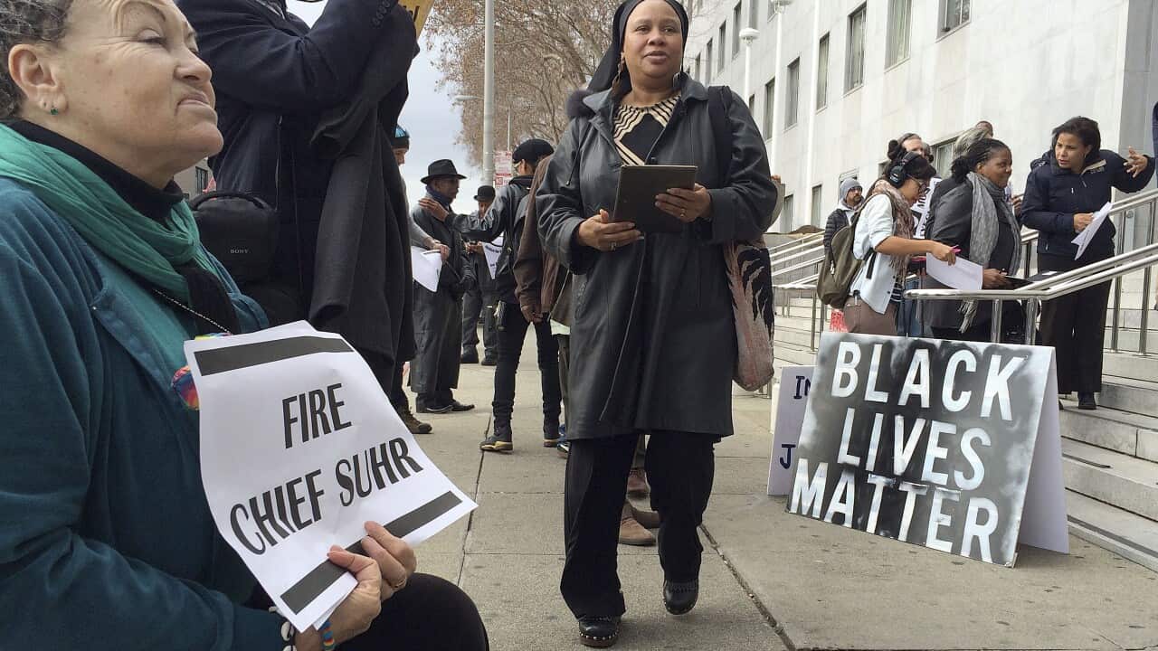 Mesha Irizarry, left, Beatrice X. Johnson, center, and other demonstrators gather in front of the Hall of Justice to protest the San Francisco police shooting death of Mario Woods and to demand the dismissal of police chief Greg Suhr in San Francisco.