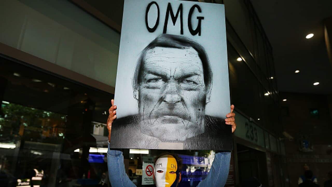 Protesters demonstrate after Cardinal George Pell arrives at Melbourne Magistrates' Court  last year.