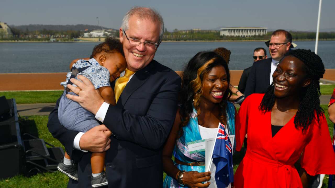 Prime Minister Scott Morrison poses for photos with new citizens during an Australia Day Citizenship Ceremony and Flag Raising event in Canberra, Jan 26, 2020