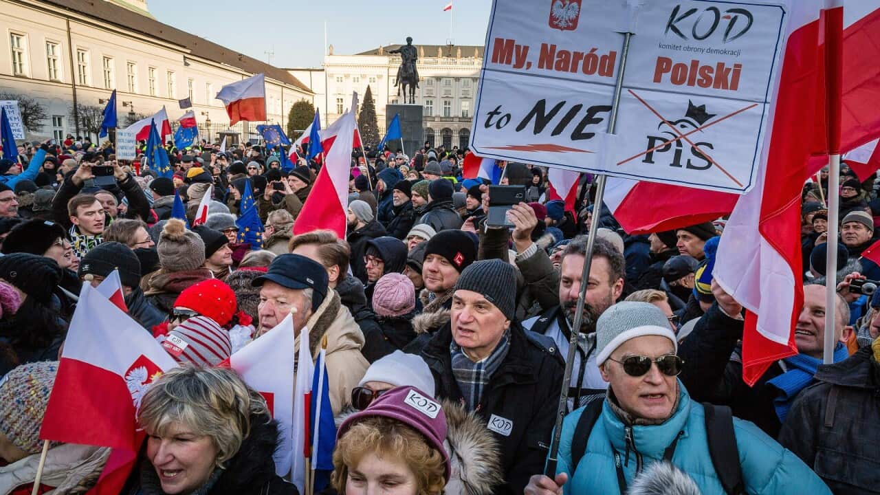 People attend an anti-government demonstration in front of the presidential Palace in Warsaw.