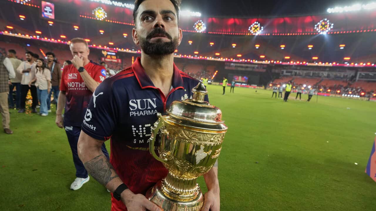 Royal Challengers Bengaluru's Virat Kohli celebrates with winners trophy after their win in the Indian Premier League final cricket match against Gujarat Titans in Ahmedabad, India, Monday, June 1, 2026. (AP Photo/Ajit Solanki)