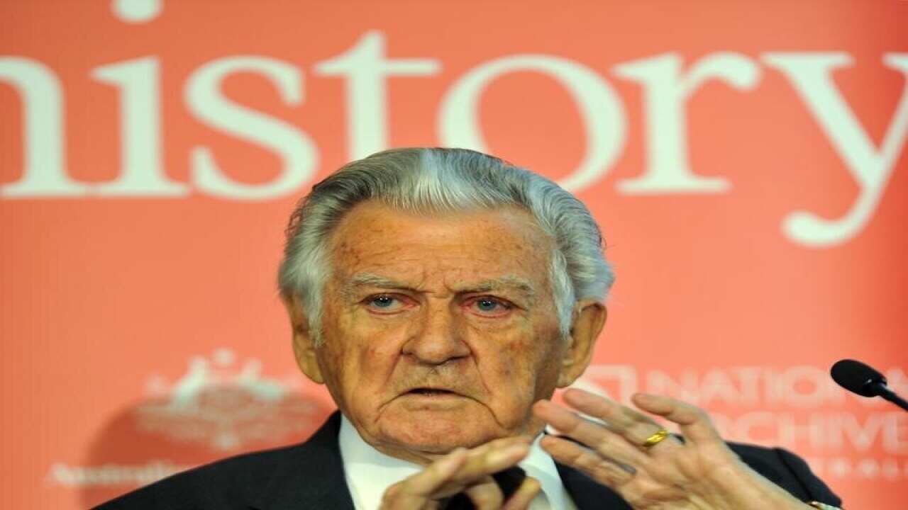 Former Prime Minister Bob Hawke gestures during a media briefing.