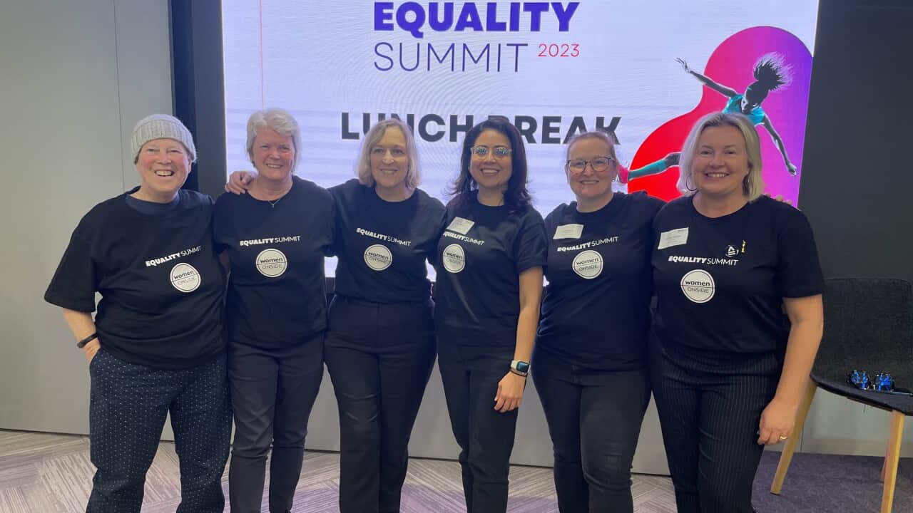 A group of women stand together.