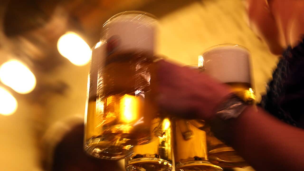 Waitress carries glasses of beer