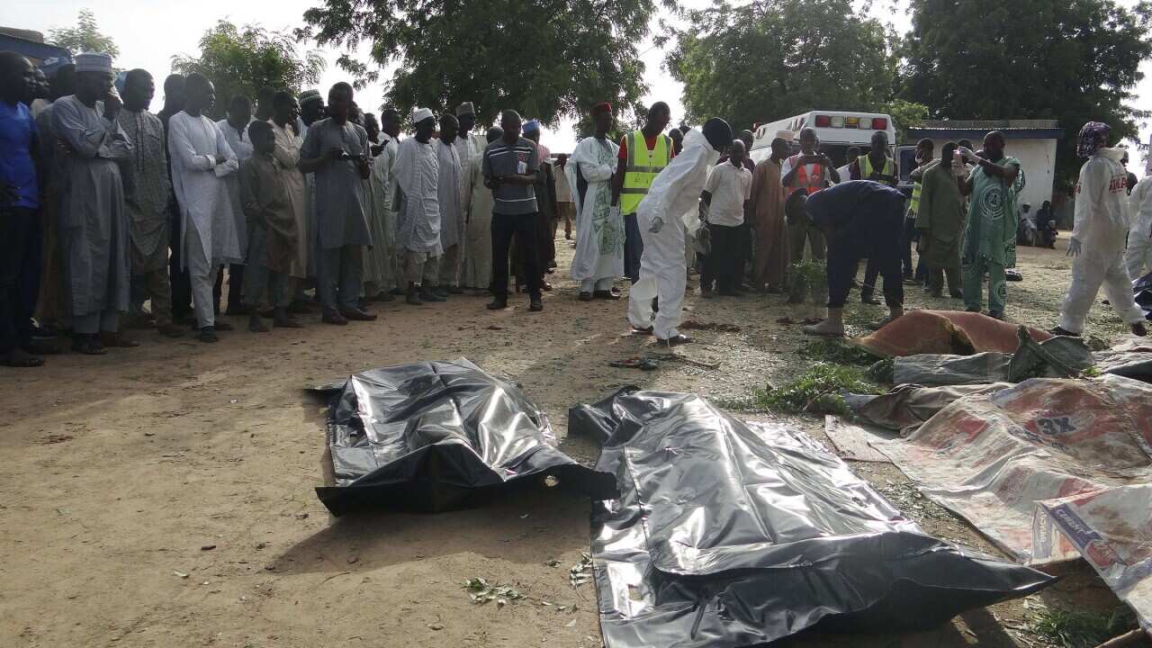 People mourn over the bodies of a suicide bomb attack victims in a village near Maiduguri, Nigeria.