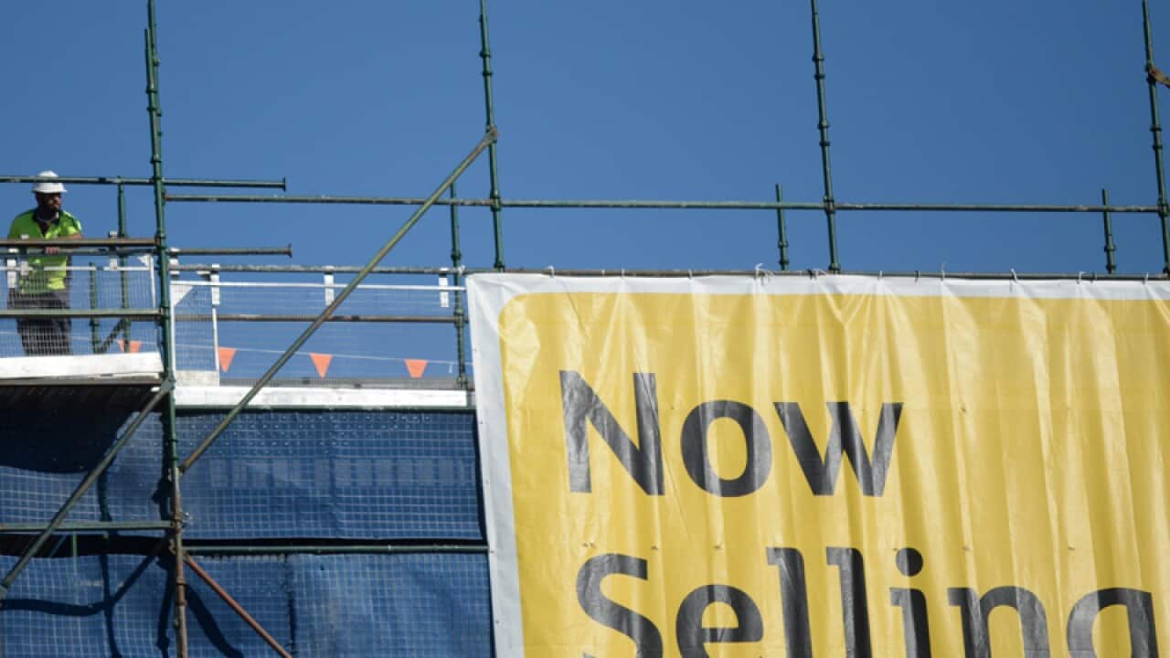 A worker on a construction site of an apartment building in Canberra
